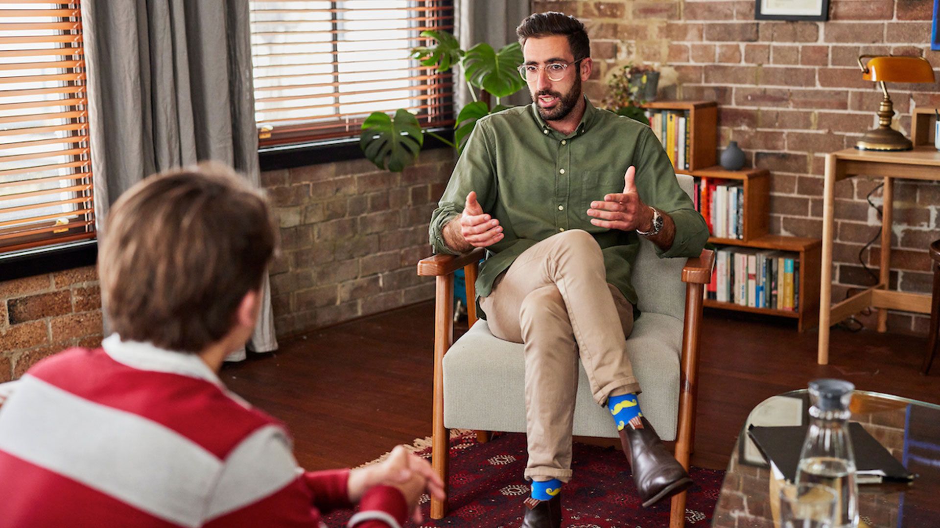 A photo of a young man in a therapy session. 