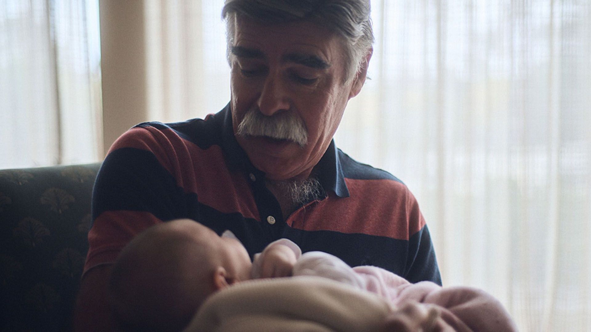 A photo of a stack of Movember-branded reports titled "The Real Face of Men's Health". 