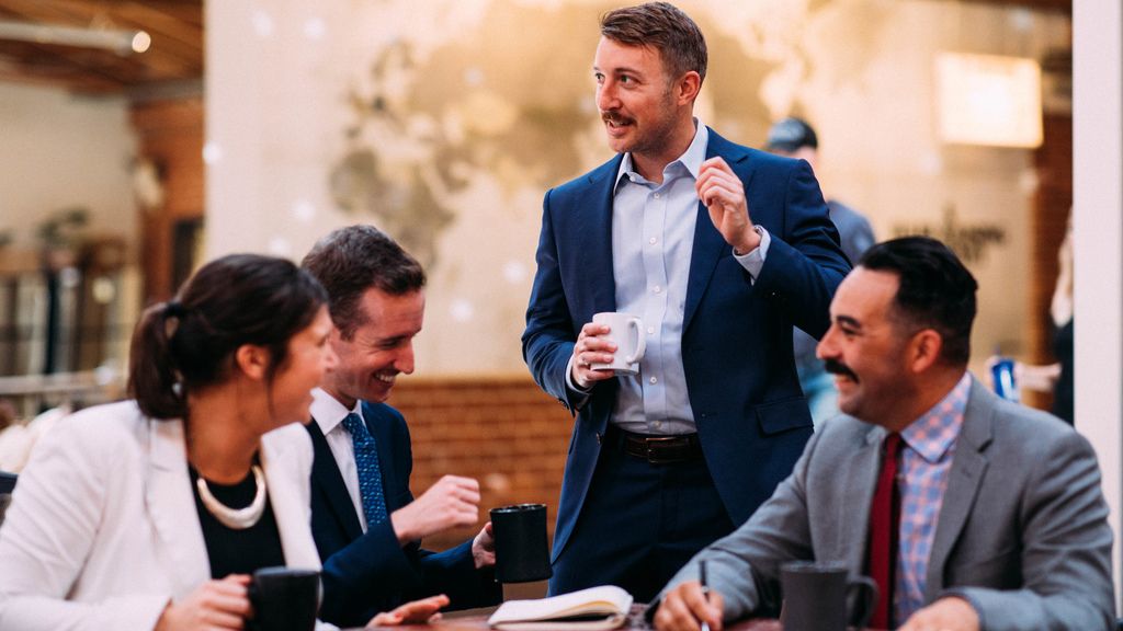 Photo of smiling corporate employees in an office.